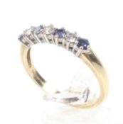 A modern 18ct gold, sapphire and diamond seven stone ring.