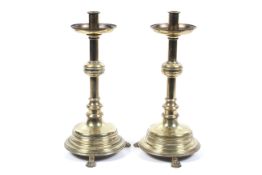 A pair of 19th century brass Gothic candlesticks.