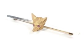 An early 20th century gold fox mask bar brooch.