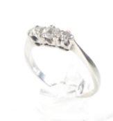 An early-mid 20th century white gold and diamond three stone ring.
