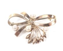 A vintage 9ct gold and cultured-pearl four stone floral-bud and ribbon-bow brooch.