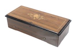 An inlaid 19th century walnut cased music box.