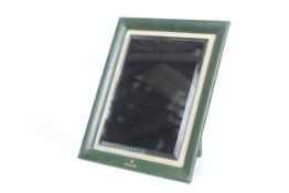 Rolex, a green leather framed easel-back table mirror.