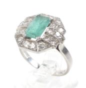 A French Art Deco emerald and diamond canted-rectangular cluster ring.