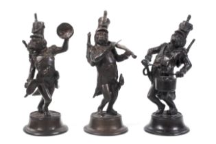 A set of three patinated bronze figures of dog musicians, circa 1900.