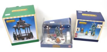 Three Lemax 'seasonal collectables'. Including Winter Gazebo, Folic in the Snow, and another.