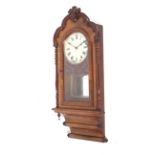 A late 19th century American eight-day walnut wall clock.