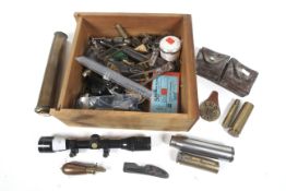 A collection of militaria items. Comprising shell casings, scope, bullet moulds etc.