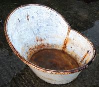 A galvanised oval hip bath.