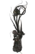 A bronze effect table lamp. Decorated with a cherub.