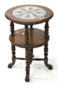 A Victorian walnut circular two tier occasional table.