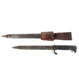 A German WWII bayonet with metal scabbard. Unmarked, with leather holdall.