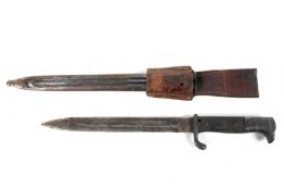 A German WWII bayonet with metal scabbard. Unmarked, with leather holdall.