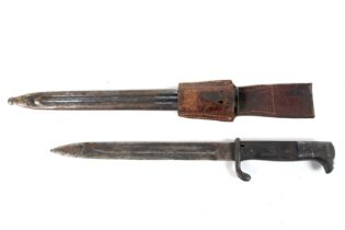 A German WWII bayonet with metal scabbard. Unmarked, with leather holdall.