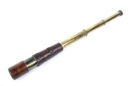 A vintage brass telescope by Broadhurst & Clarkson, London. With leather cover (some damage).