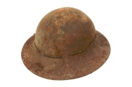 A British steel helmet, marked EC & Co, 8/41. With leather lining and leather threading.