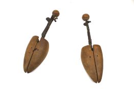 A pair of antique shoe stretchers. Stamped 'Andersons Fitall. Fits 5-8 #3'.