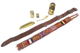 A collection of Trench Art items and two belts.
