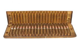 A Dutch wooden cigar mould, containing cigars.
