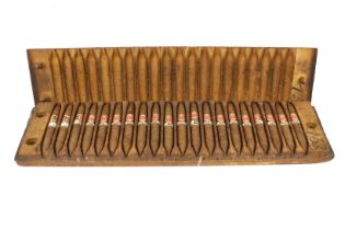 A Dutch wooden cigar mould, containing cigars.