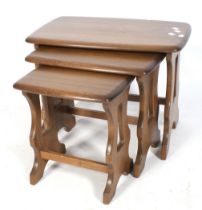 A mid-century Ercol nest of three tables. Stained wood with rounded corners.