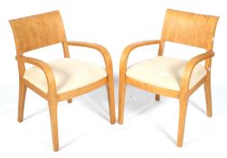 A pair of Dwell solid oak framed open armchairs. With cream suede leather seats.