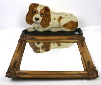 A gilt framed wall mirror and a 'King Charles dog' wooden cut out.
