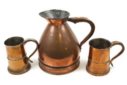 A copper jug and two tankards.