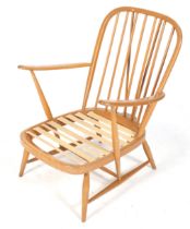 A mid-century Ercol stick back 'cottage' armchair. On turned supports united by turned stretchers.