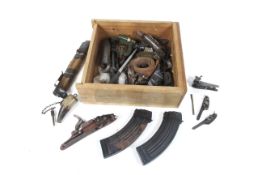 A collection of militaria items. Comprising magazines, flintlock barrels, mechanisms etc.