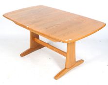 A mid-century Ercol extending dining table.
