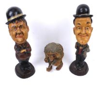 A pair of Laurel and Hardy figures and a carved wooden goblin. Max.