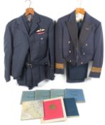 Two RAF uniforms and six pilot log books.