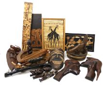 An assortment of treen and African tribal ornaments. Including a mask, figures, animals, etc.