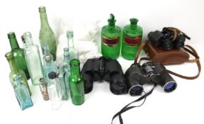 An assortment of collectables. Including vintage bottles, a pair of binoculars, etc.