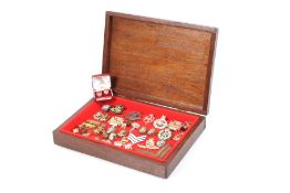 A wooden box containing a selection of military items.