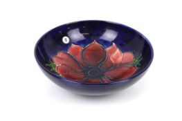 A Moorcroft pottery shallow small dish. Decorated with poppy head.