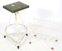 A mid-century industrial work stool and an 'atomic' magazine rack.