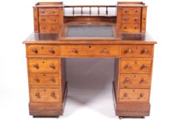A 19th century stained oak 'DICKENS' desk with slope.
