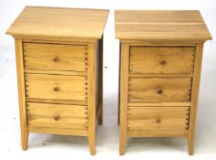 A pair of contemporary oak bedside cabinets.