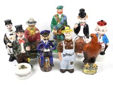 A collection of novelty ceramic decanters. Modelled as musicians, workmen, etc.