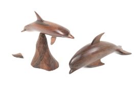 A pair of vintage carved wooden dolphins.