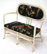 A vintage child's two seater wicker chair.