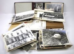 A large collection of vintage black and white photographs.