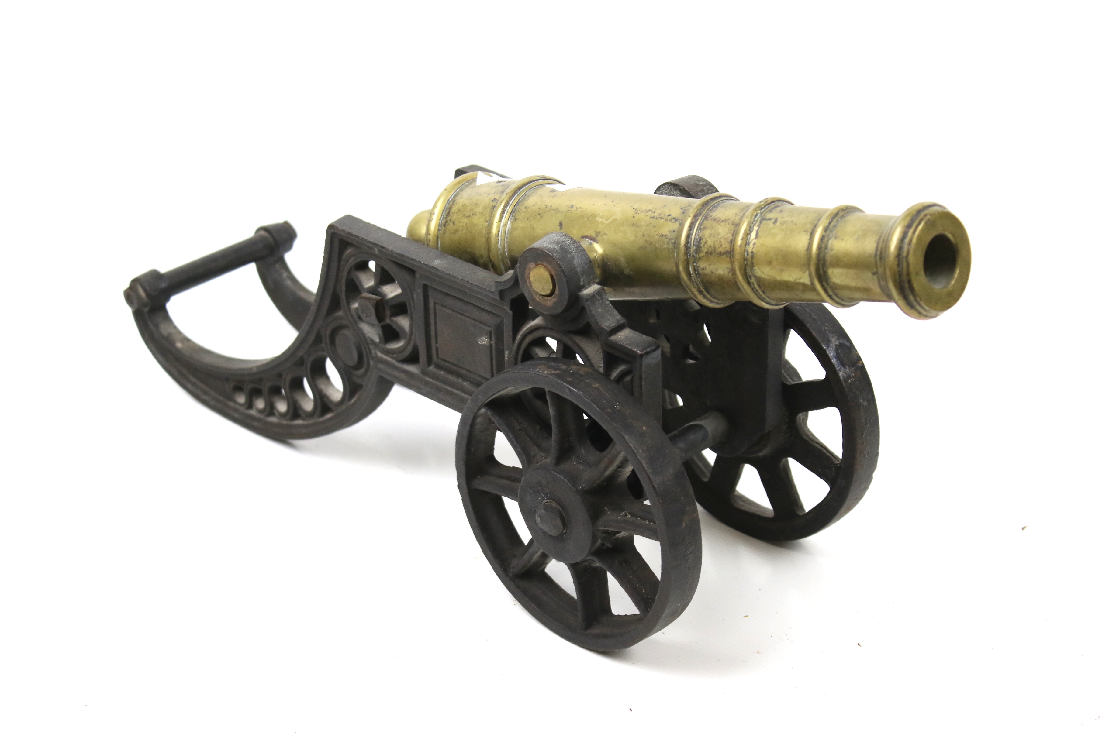 A brass replica of a canon. Mounted on a metal carriage.