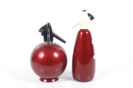 Two red mid-century Sparklets soda syphons. Including 'Globe Master' s/n SE/W/T and s/n. SHUS. Max.