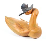 A wooden sculpture of a 'Great Crested Grebe' by Simon Granger. With a metal beak and head piece.