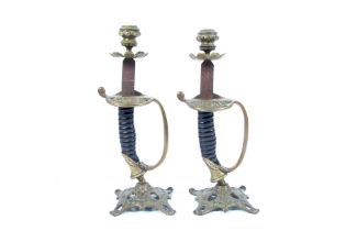 A pair of sword hilt candlesticks.