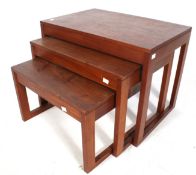 A mid-century stained oak nest of three tables.