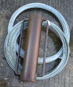 Two reels of heavy duty wire and fence post rammer/driver.